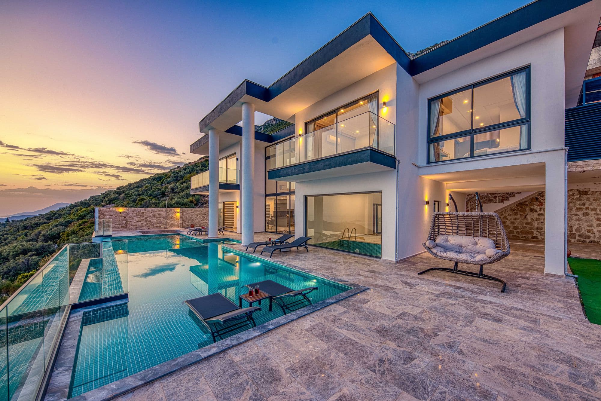 Modern villa with an infinity pool at sunset